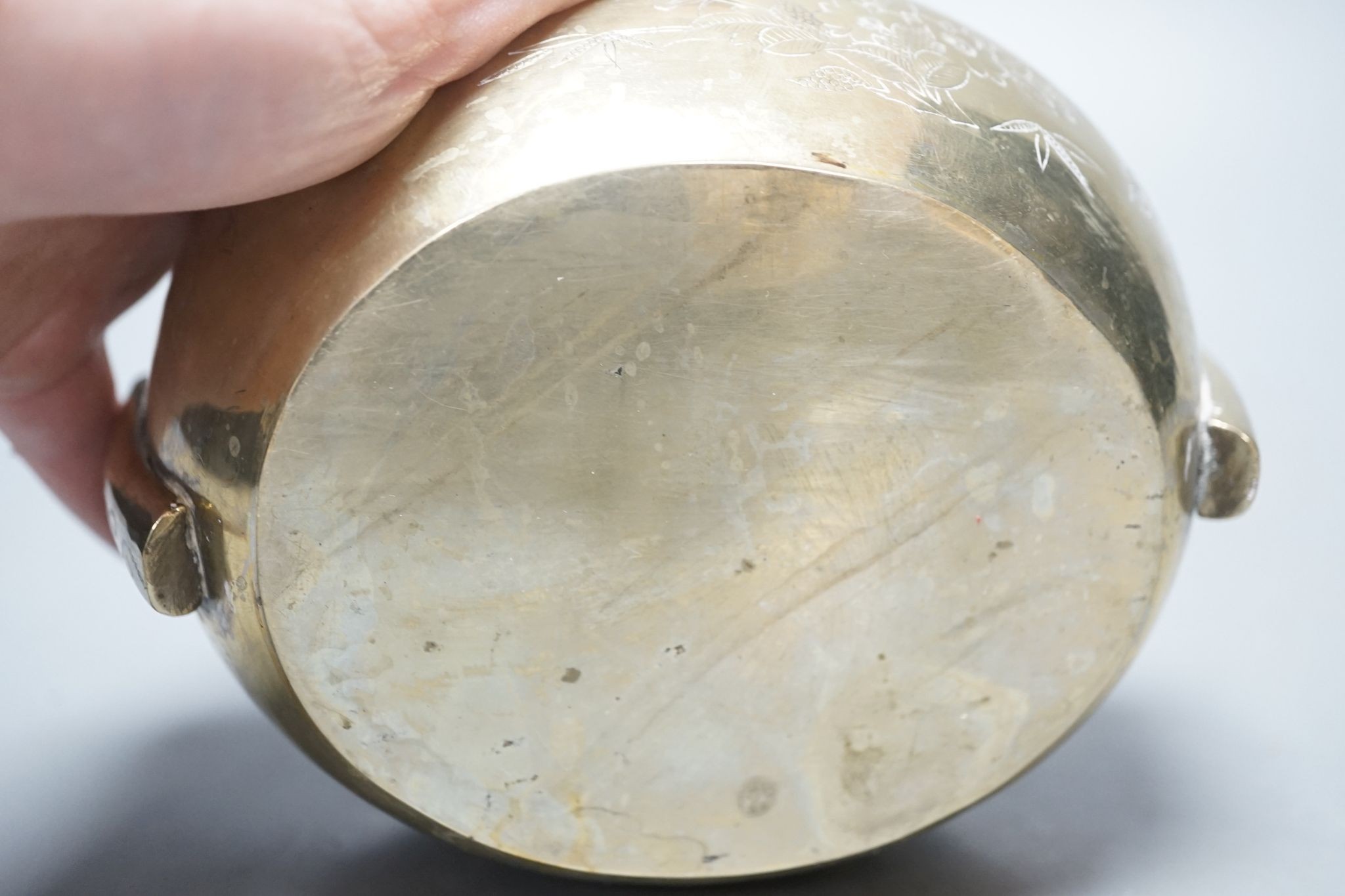 A Chinese bronze tripod censer, 13.5cm and two brass or bronze hand warmers